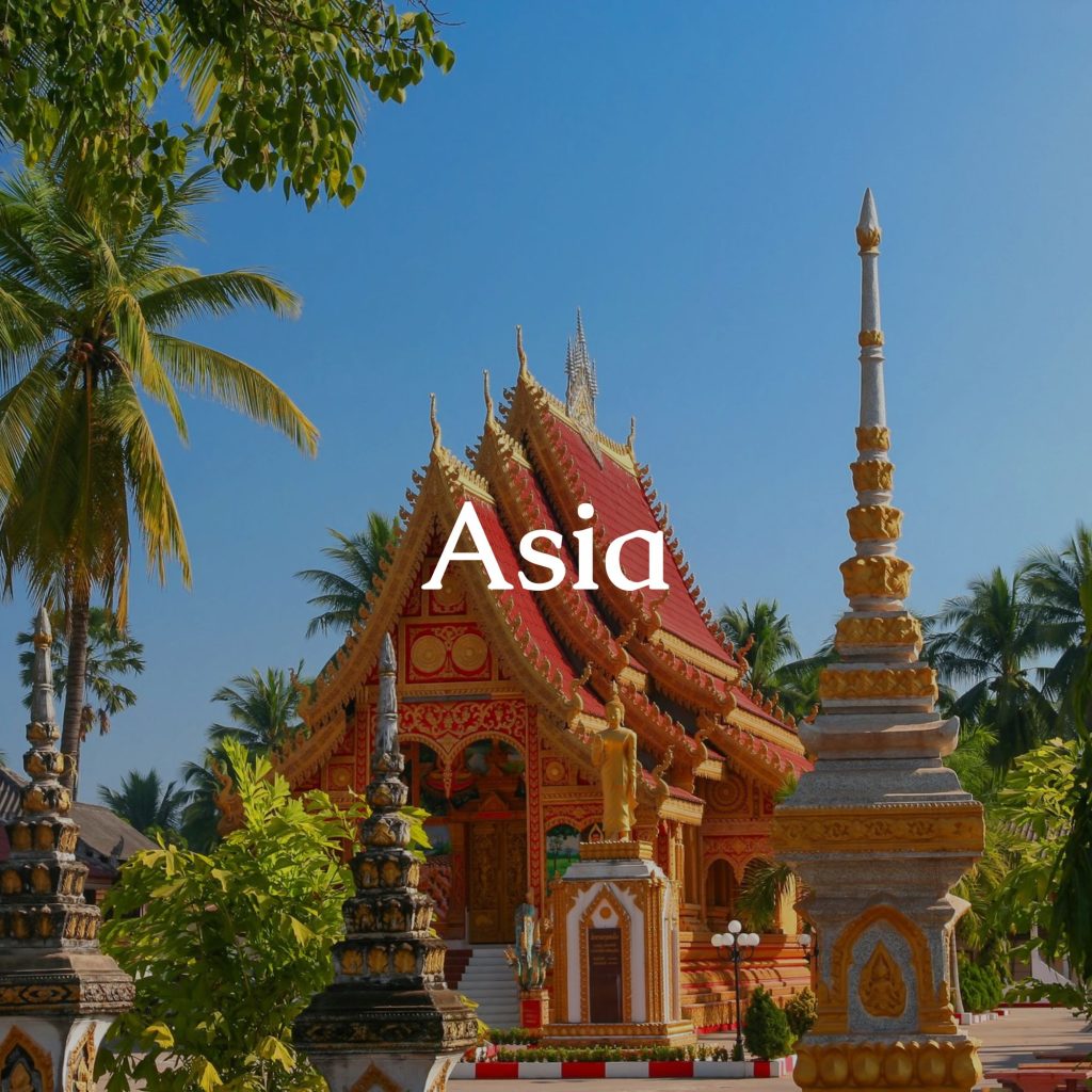 Ornate temple with palm trees and various roofs. In the foreground, the sign 'Asia'.